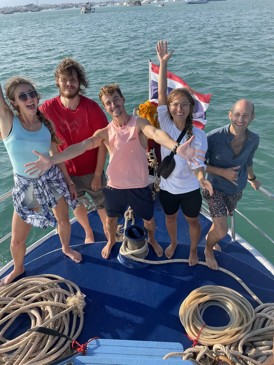 Students and an instructor together on a boat with the sea behind them